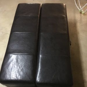 Black leather ottoman pulls out to a single bed.